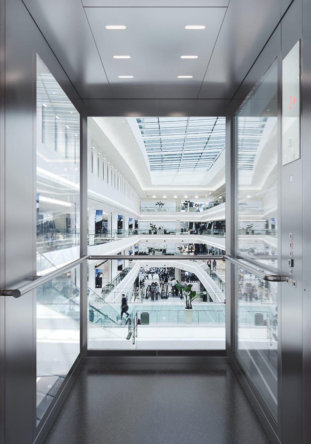 Blick durch einen Lift mit Fenstern. Man sieht in ein Bürogebäude, wo viel Trubel herrscht.
